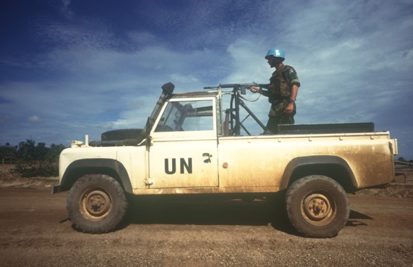 CAMBODIA, Thmar Pouk, Dutch made UN jeep with a soldier standing behind a mounted rifle in the back