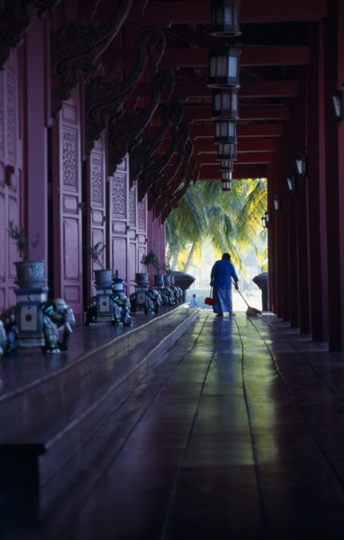 MALAYSIA, Kedah, Langkawi, The Summer Palace on Pantai Kok beach with woman sweeping the floor of