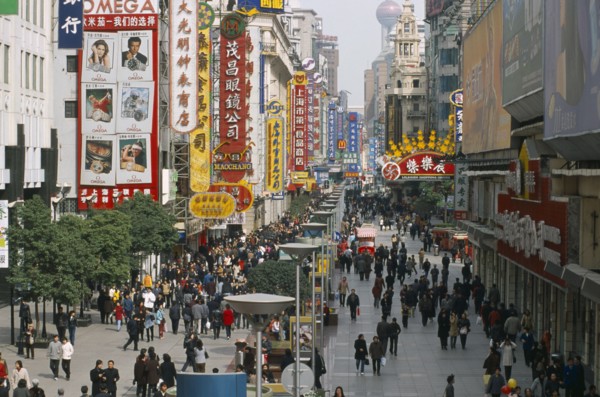 CHINA, Shanghai, Pedestrianised street crowded with shoppers and lined with advertising hoardings