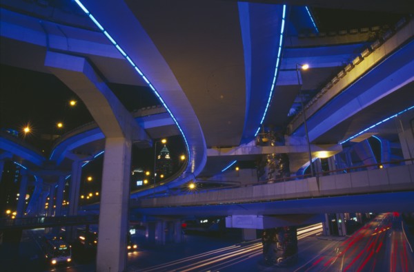 CHINA, Shanghai, "Bridge and intersecting roads seen from below, lit by ultra violet light at night