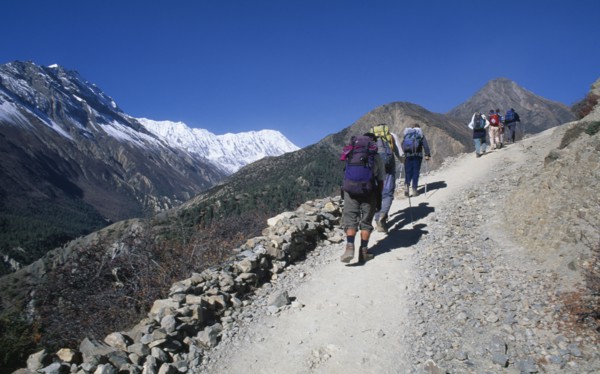 NEPAL,  , Annapurna, "Group of trekkers carrying rucksacks walking up steep mountain path, seen
