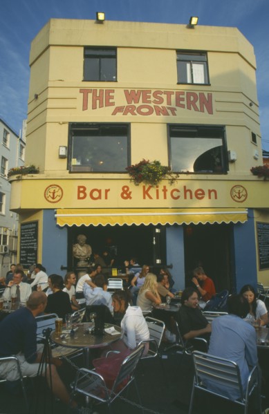 ENGLAND, East Sussex , Brighton, City bar and restaurant with open front and people sitting at
