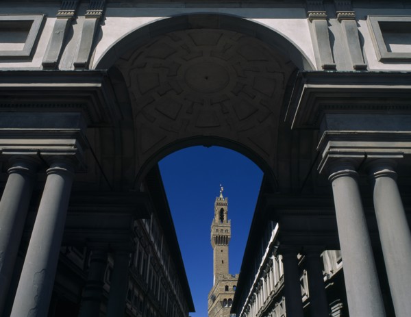ITALY, Tuscany, Florence, Palazzo Vecchio.  View through colonnaded archway towards the Campanile.