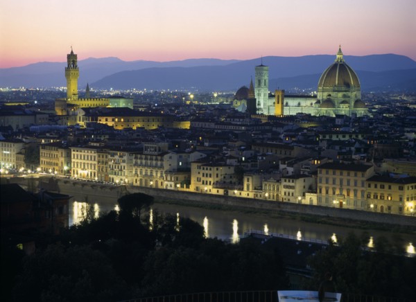ITALY, Tuscany, Florence, View over city at dusk with the Duomo illuminated and street lights