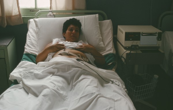 CUBA, Havana, Pregnant mother in hospital bed attached to monitor