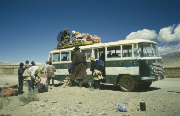 TIBET, Tranport, Bus, Bus in the countryside being loaded with goods by passengers