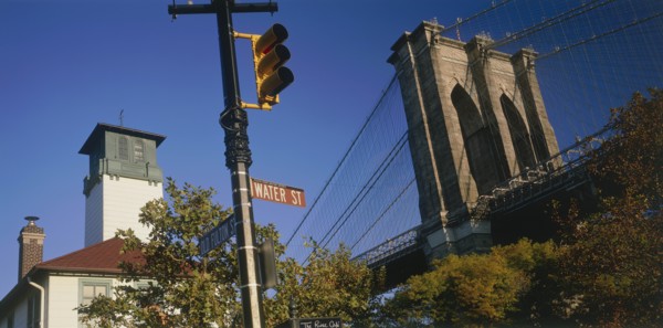 USA, New York State, New York, Part view of Brooklyn Bridge seen above trees with road sign and
