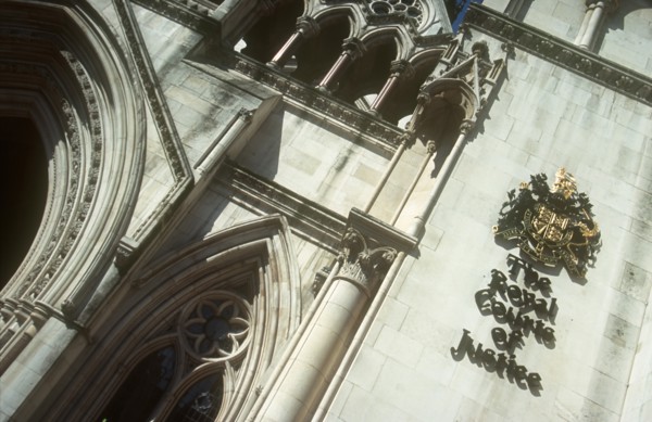 ENGLAND, London, Royal Courts of Justice. View looking up at the building with the crest displayed