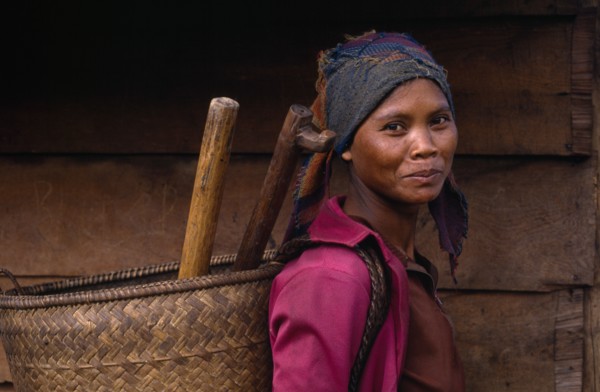 20022935 VIETNAM People Single Women Smiling young woman carrying woven basket on her back  head and shoulders portrait.