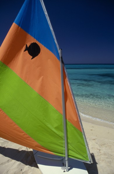 WEST INDIES, Jamaica, Transport, "Sail board with colourful, striped sail pulled up on sandy beach