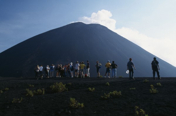 GUATEMALA, Pacaya Volcano, Crater view of the volcano with a line of people looking toward the