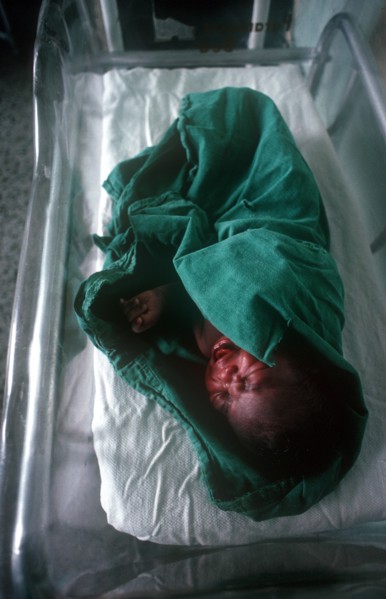 CUBA, Havana, Newborn baby wrapped in green towel in maternity hospital