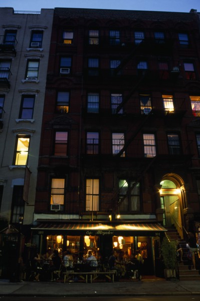 USA, New York, New York City, East Village. Cafe Mogador with tables and chairs under awning and