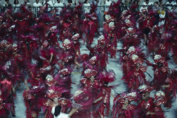 BRAZIL, Rio de Janeiro, Carnival procession of dancers wearing red feathered costumes