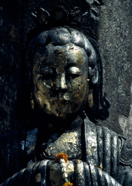 THAILAND, Bangkok, Wat Phra Kaew, Or Royal Palace. Close up detail of golden statue with floral