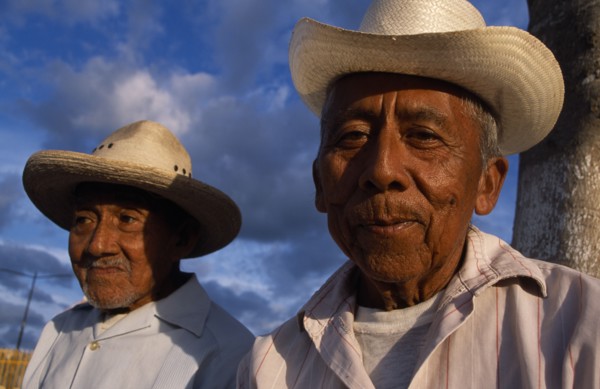 20026145 MEXICO Yucatan Hoctún Two smiling  elderly men in hats  head and shoulders portraits one slightly behind other.