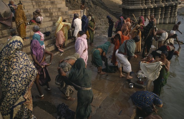 INDIA, Uttar Pradesh, Varanasi, People gathered on the ghats and bathing in the River Ganges