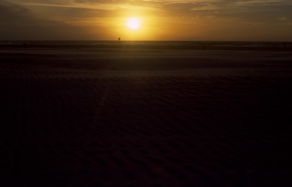 USA, Florida, Clearwater, Clearwater beach at sunset with bright orange sun over the sea.
