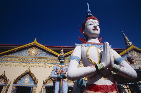 MALAYSIA, Penang, Georgetown, "Wat Chayamangkalaram.  Exterior, temple statues with part view of