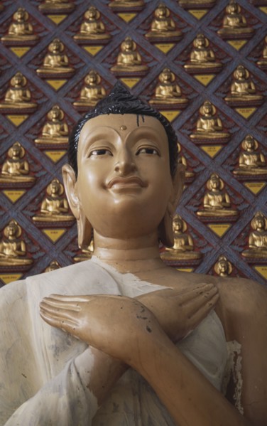 MALAYSIA, Penang, Georgetown, Wat Chayamangkalaram.  Detail of Buddha figure with hands crossed