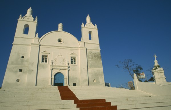 INDIA, Gujarat, Diu, Church of St Thomas. White painted exterior facade with painted red central