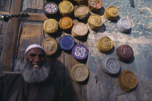 PAKISTAN, Baluchistan, Quetta  , Vendor with display of muslim caps for sale.