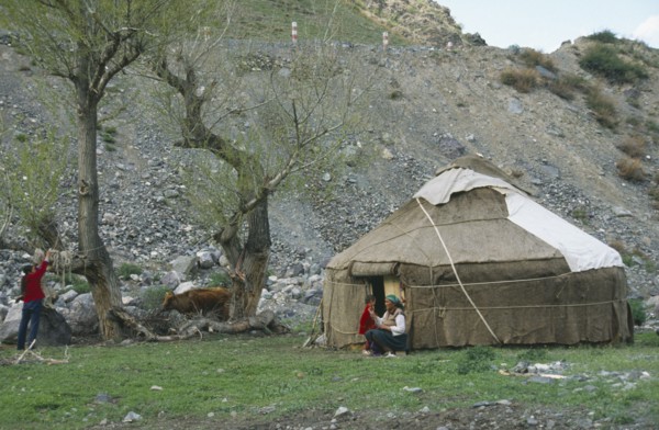 CHINA, Xinjiang , Tianchi, "Kazakh Yurt, tent, with women and young boy outside"
