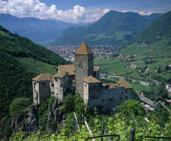 ITALY, Trentino Alto Adige, Bolzano, View over distant mountain village Karneid castle in