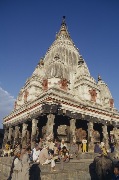 NEPAL, Religious, Bungamati Temple exterior with people gathered on the steps and golden spire