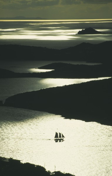 WEST INDIES, US Virgin Islands, St Thomas, Silhouette of two masted sailing ship with three sails