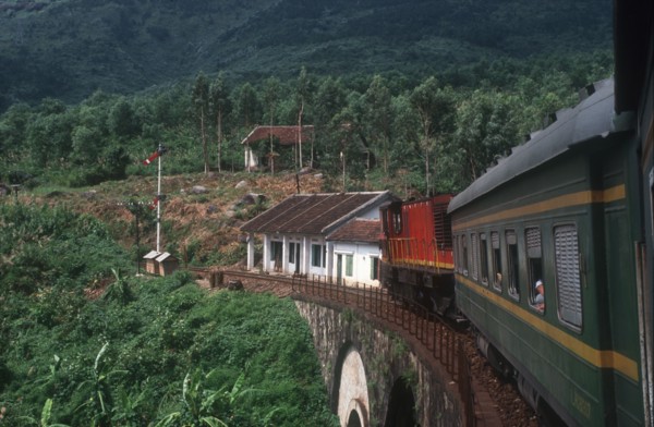 VIETNAM, Hai Van Pass , View from train along carriages as it crosses a bridge surrounded by lush