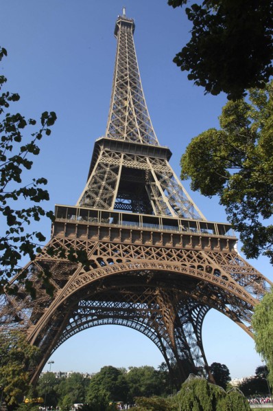 FRANCE, Ile de France, Paris, Angled view looking up at the Eiffel Tower