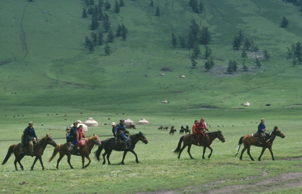 CHINA, Xinjiang Province, Kazakhs, Kazakh people on horseback on their way to the horse races