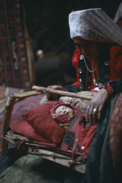 AFGHANISTAN, People, Kirghiz woman with baby inside yurt.