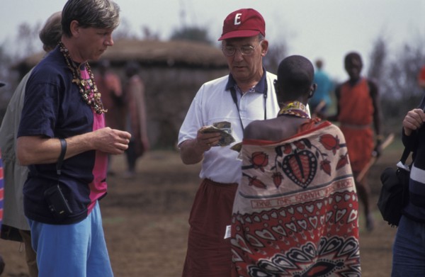 KENYA, , An American tourist haggles with a Maasai woman in a cultural manyatta set up to interface