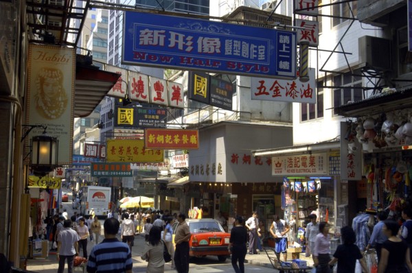 HONG KONG, General, View along busy city street with passing traffic and pedestrians and overhead