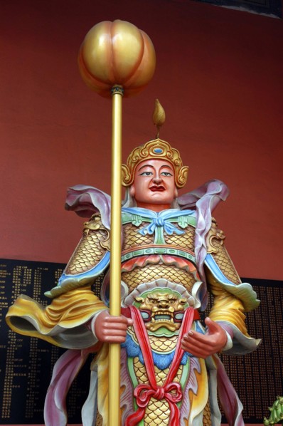 MALAYSIA, Kuala Lumpur, Chinatown, Colourful statue of a figure holding a staff