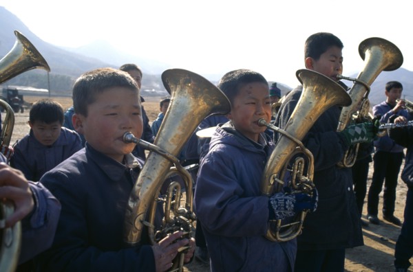NORTH KOREA, Hwanghae Bukto, Juche ideology.  Pyongsan County band encouraging workers as they