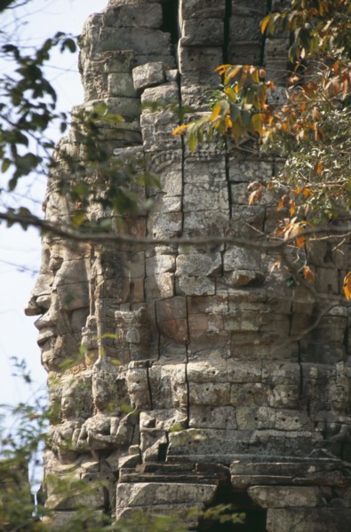 CAMBODIA, Siem Reap, Angkor, Ta Prohm monastic complex detail of the four faced west gate seen