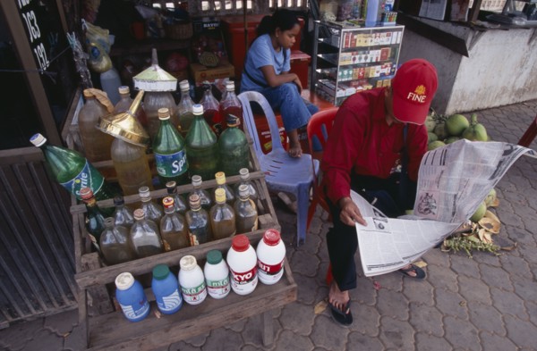 CAMBODIA, Siem Reap, Roadside stall selling bottles of petrol watered down and at the same price as