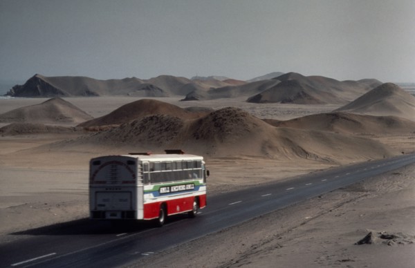 PERU, Landscape, Bus on the Pan American highway through coastal desert connecting Ecuador and