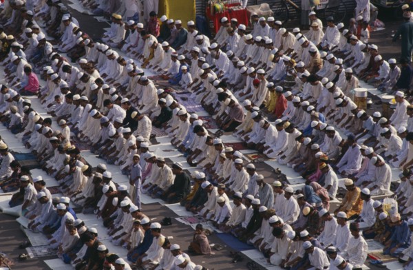 BANGLADESH, Dhaka, Rows of Muslims kneeling in prayer.