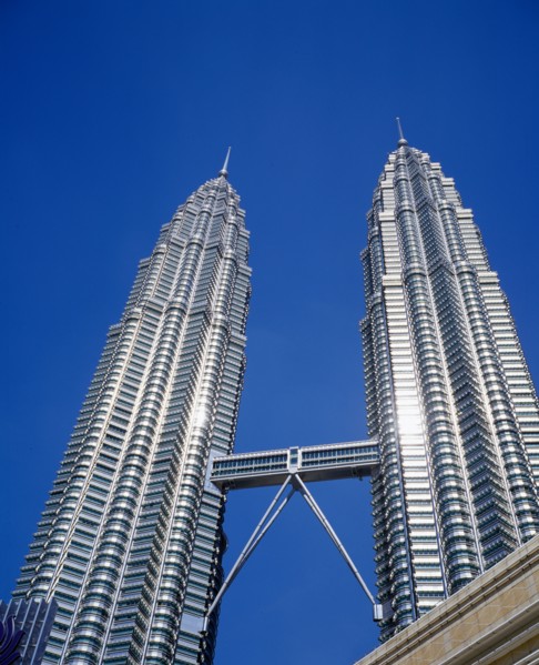 MALAYSIA, Kuala Lumpur, Petronas Twin Towers. Angled view looking up at the multi storey buildings