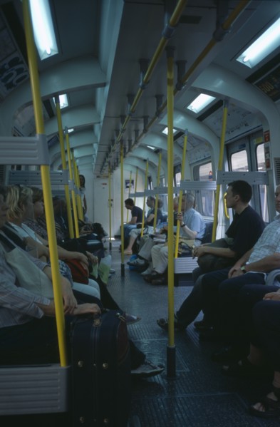 20059178 ENGLAND  London The London Underground. Interior view through the train carriage with passengers sitting on seats.