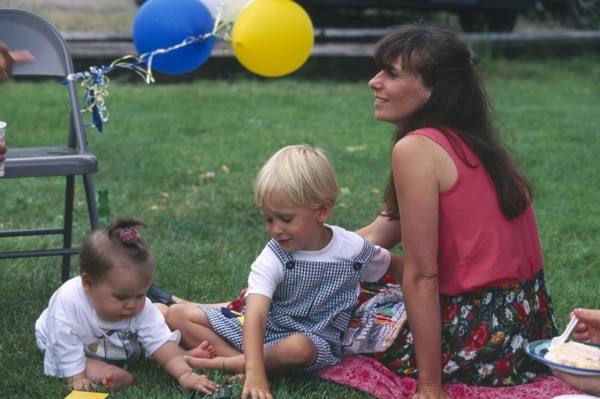 USA, Rhode Island, Westerly, Woman and two young children at barbecue.