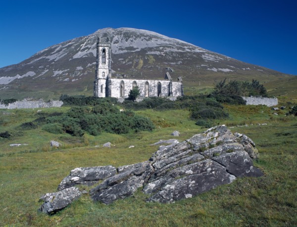 IRELAND, Donegal, Mount Errigal, Ruined church in The Poisened Glen with Errigal peak of the