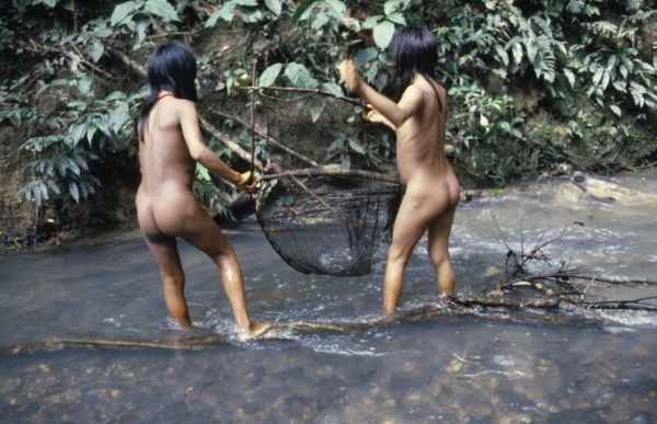 ECUADOR, Amazon, Auca, Two Auca Indian girls fishing with net.
