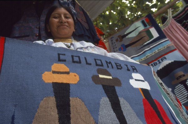 COLOMBIA, Amazonas, Leticia, Ecuadorean Otavalan Indian woman selling textile souvenirs.