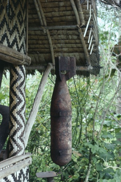 MELANESIA, Soloman Islands, Cargo cult bomb found and been venerated and hanging outside a wooden