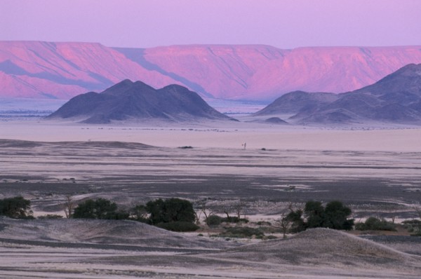 NAMIBIA, Namib Desert, Desert mountains and plains with pink and purple sky overhead